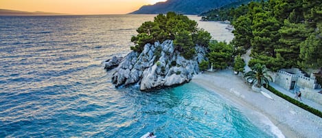 On the beach, sun loungers, beach umbrellas, scuba diving