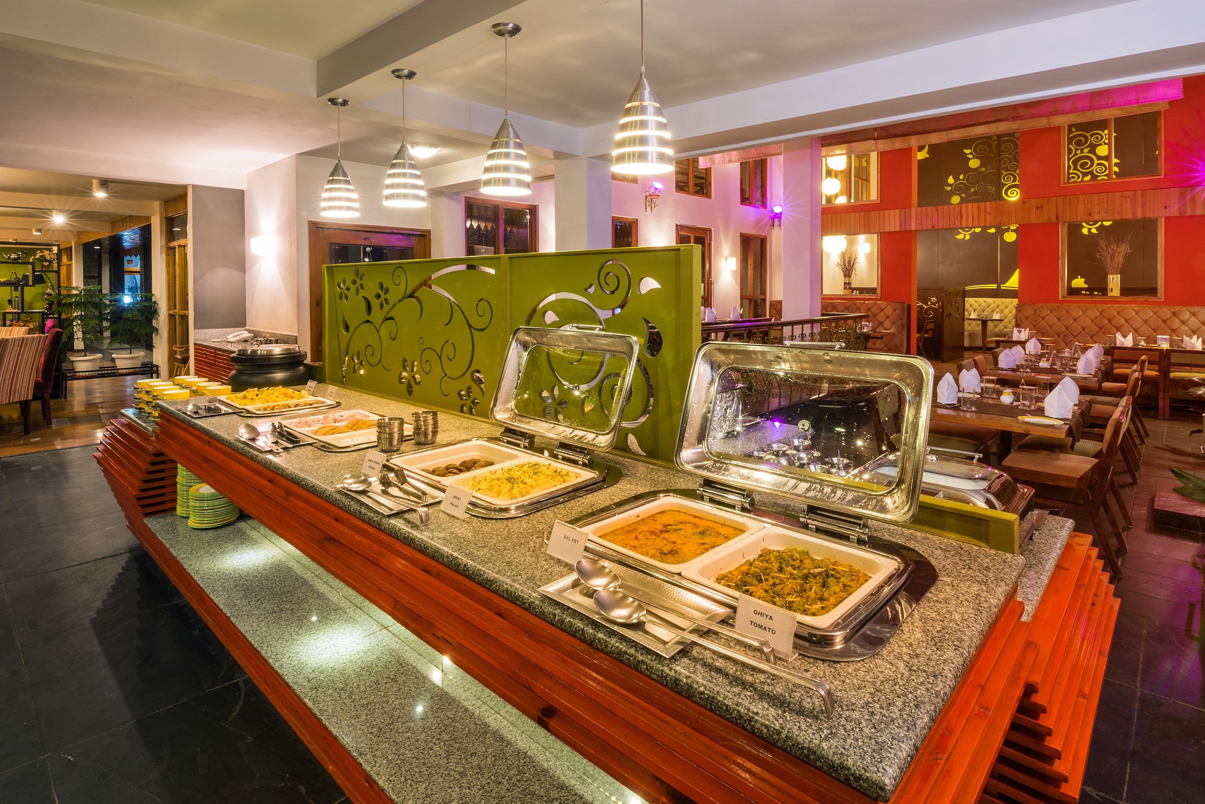 A buffet area with multiple food stations, including labeled dishes like 'Ginger Tomato' and 'Pasta'.