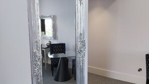 A large ornate mirror with a silver frame in a room with a patterned carpet and a white wall. - Dean Park Hotel (Kirkcaldy)
