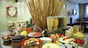 A buffet with various food items and beverages. - Trieste Hotel (Rimini)