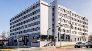 A modern hotel building with a prominent Premier Inn sign, multiple floors, and a visible entrance with a staircase. - Premier Inn Nürnberg City Nordost (Nuremberg)