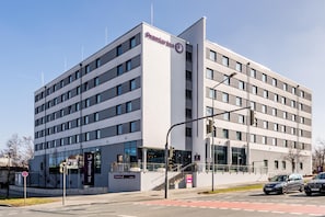 A modern hotel building with a prominent Premier Inn sign, multiple floors, and a visible entrance with a staircase. - Premier Inn Nürnberg City Nordost (Nuremberg)
