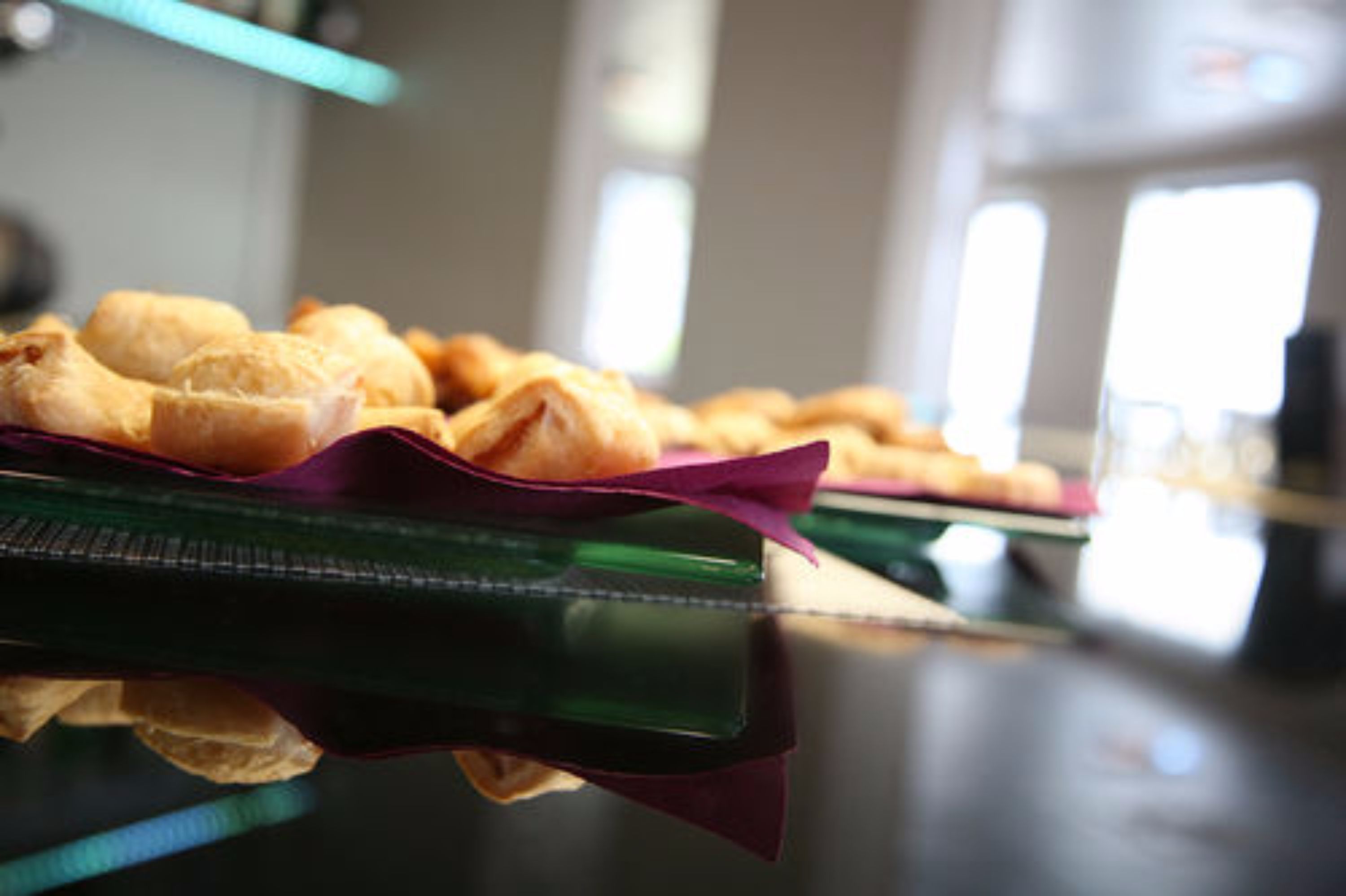 A tray of pastries on a reflective surface.
