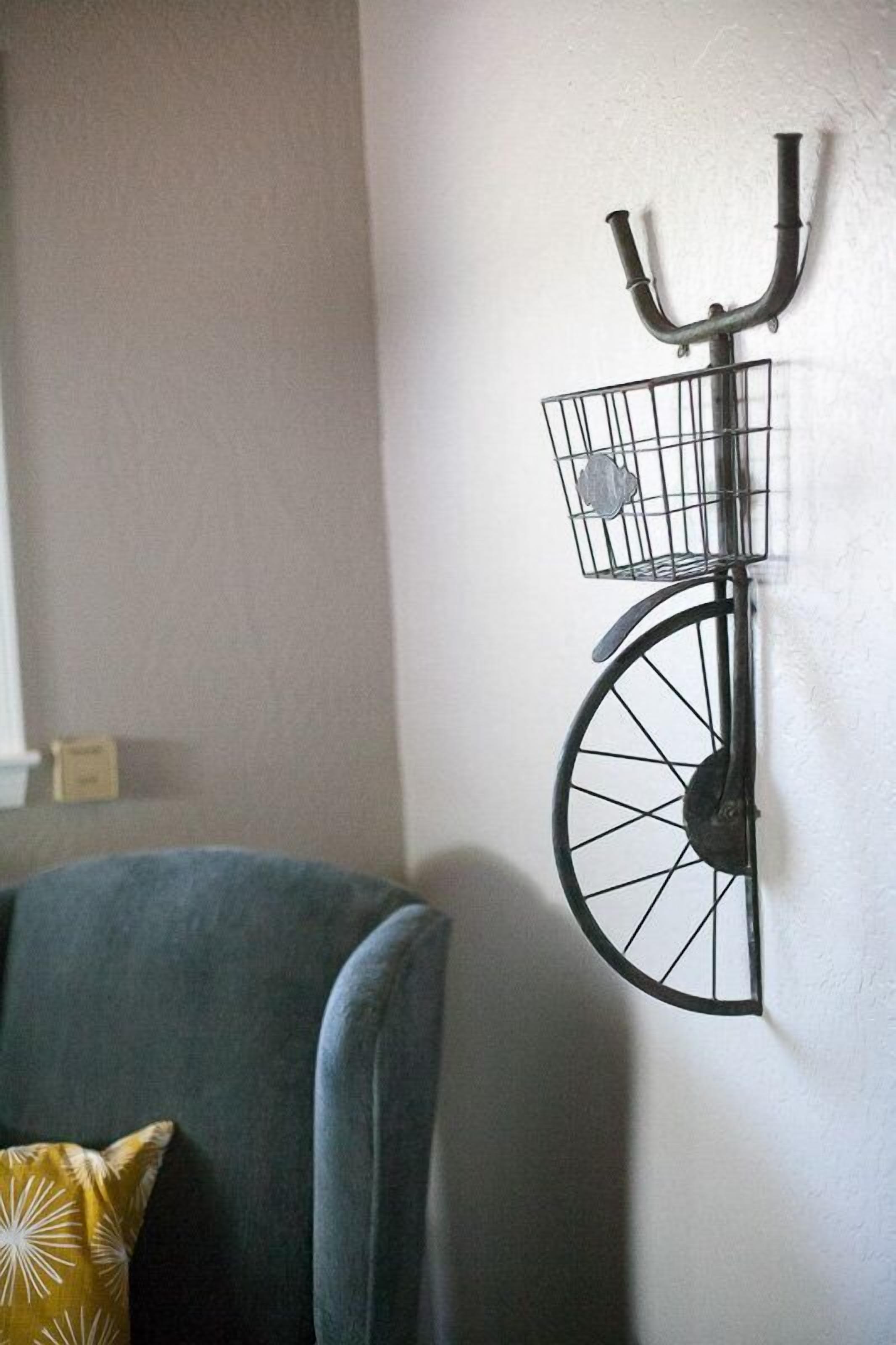 A wall-mounted bicycle rack with a basket.