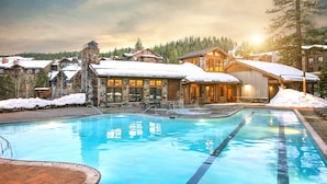 A resort with a swimming pool, stone buildings, and snow-covered roofs. - Hyatt Vacation Club at Northstar Lodge, Lake Tahoe (Truckee)