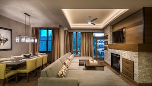 A modern living room with a sectional sofa, dining area, fireplace, and large windows. - Hyatt Vacation Club at Northstar Lodge, Lake Tahoe (Truckee)