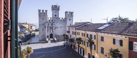 A historic square with a castle, cobblestone streets, and traditional buildings.