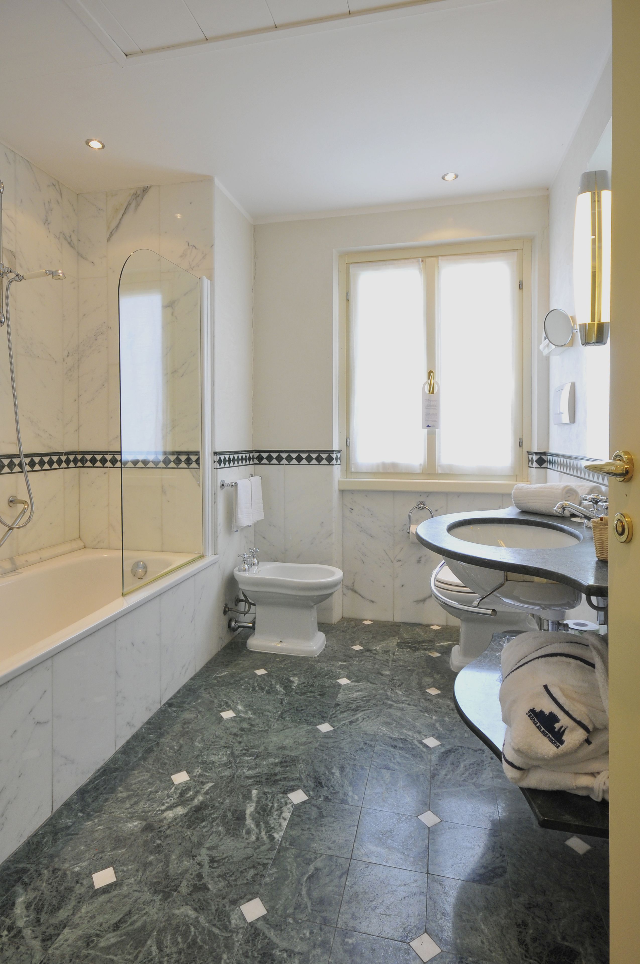 A bathroom with a bathtub, toilet, and sink.