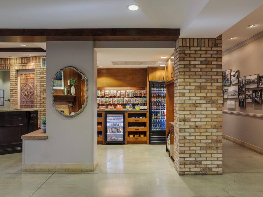 A lobby with a reception desk, a vending machine, and a display of snacks.