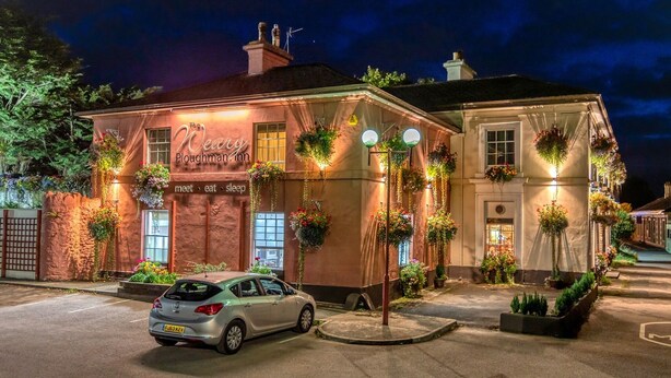 A building with a sign reading "The Weary Ploughman Inn" and a car parked in front. - The Railway Inn (Brixham)