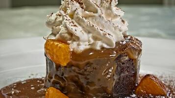 A dessert with whipped cream and caramel sauce.