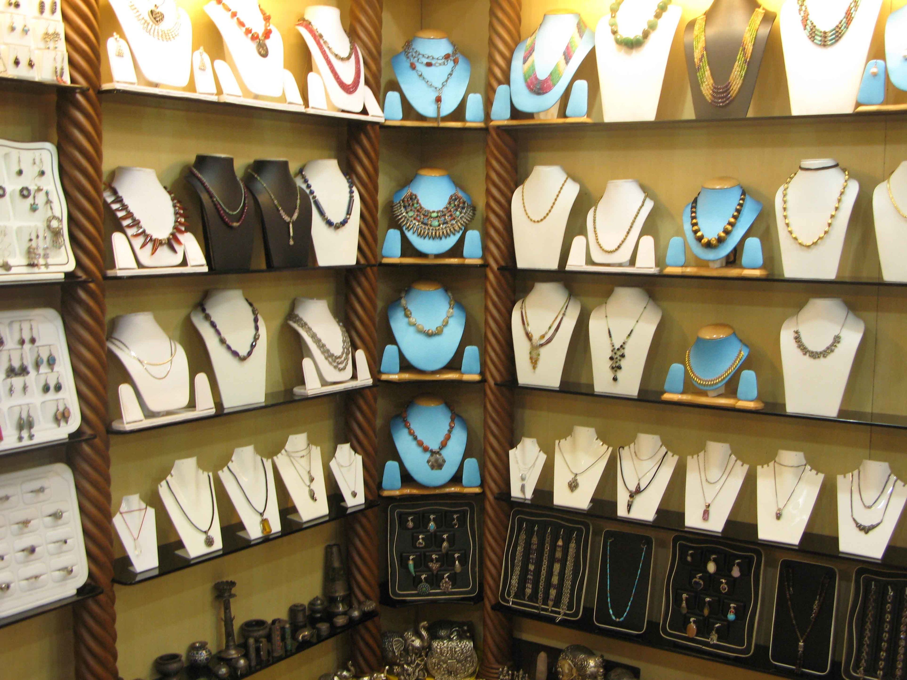 A jewelry store with multiple display cases of necklaces and earrings.