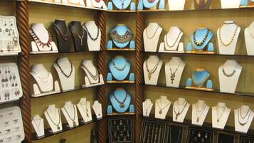 A jewelry store with multiple display cases of necklaces and earrings.