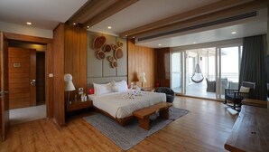 A spacious bedroom with a large bed, wooden paneling, a bench, and a view of the balcony. - Moksha Himalaya Spa Resort (Kasauli)