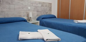 A hotel room with two beds, each with blue bedding and white towels. - Trebol One Apartments By Mc (Benidorm)