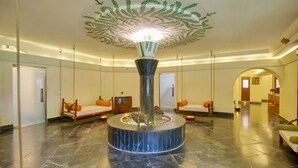 A lobby with a central fountain, seating areas, and a distinctive ceiling design. - Clarks Khajuraho (Rajnagar)