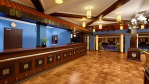 A spacious lobby with a reception desk, a clock, and a pool area. - Casa De Goa Boutique Resort (Calangute)