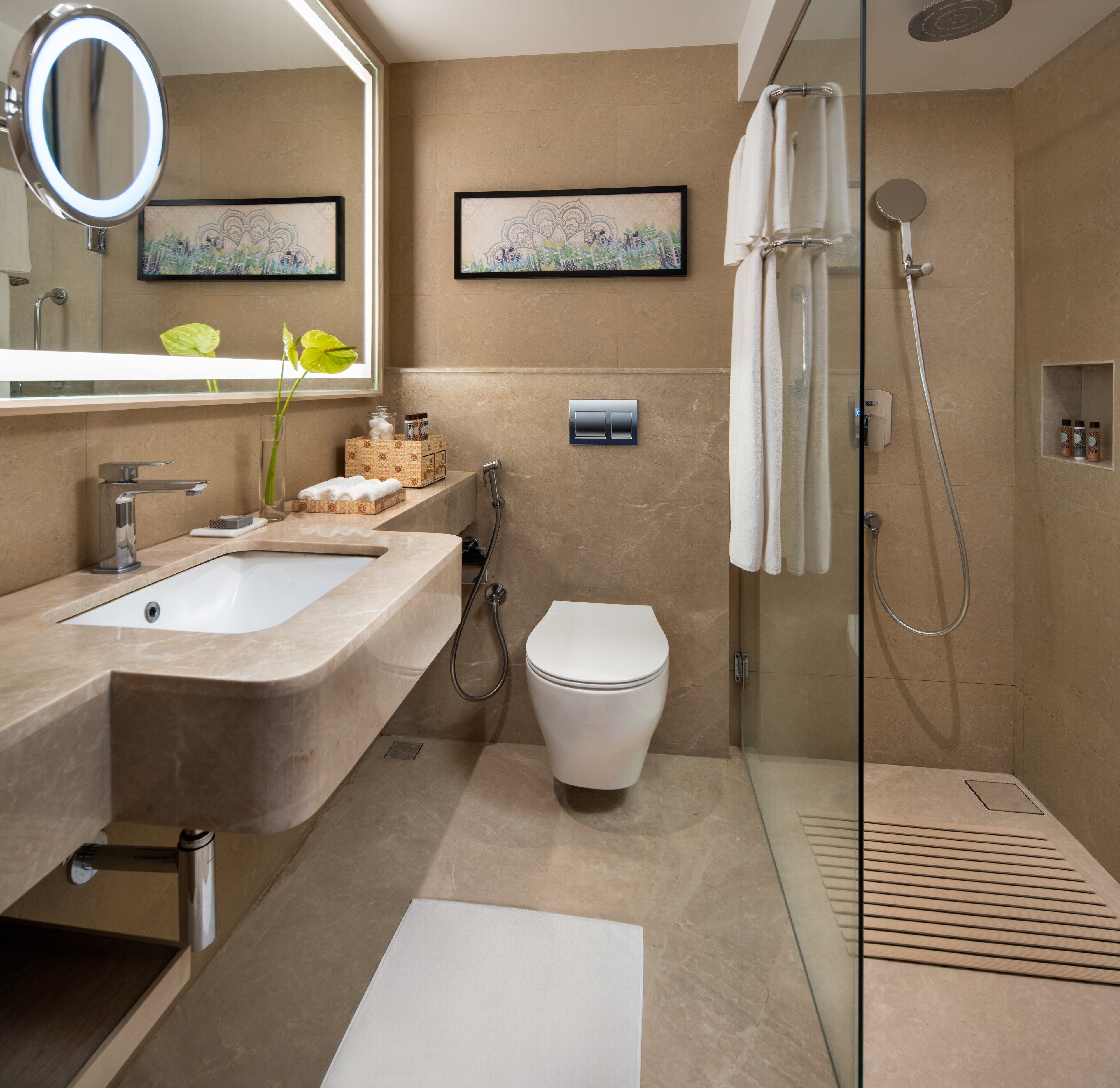A modern bathroom with a sink, toilet, and shower area.