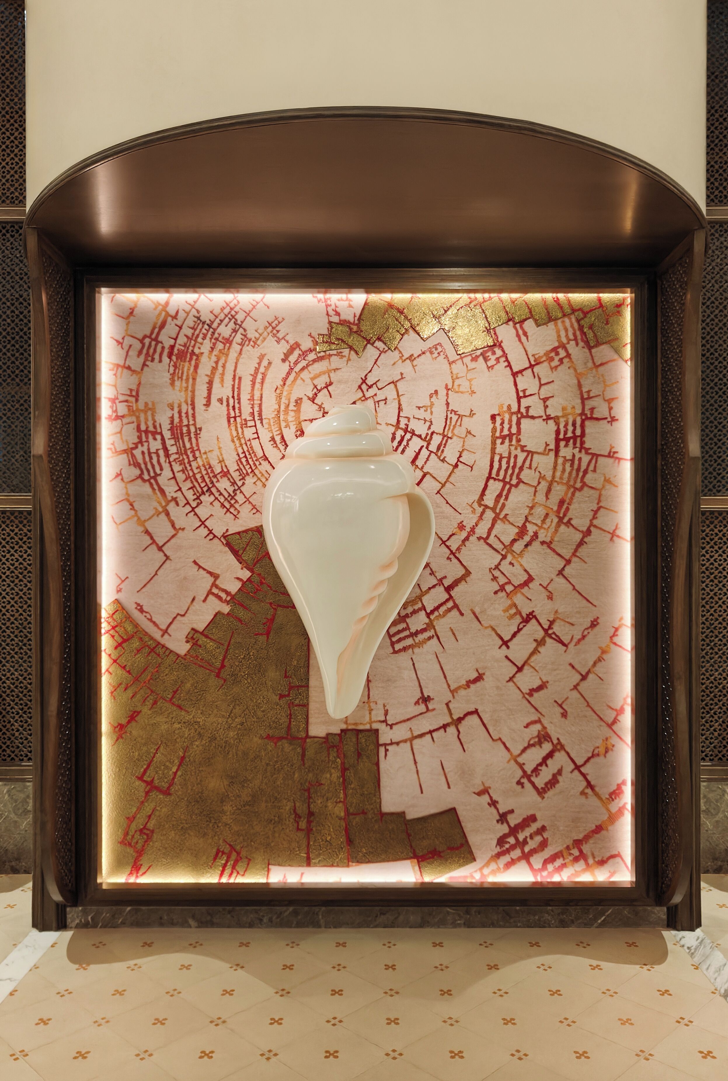 A framed artwork with a geometric pattern and a central white vase.