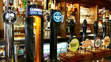 A bar with various beer taps including Guinness, St. Louis, and others.