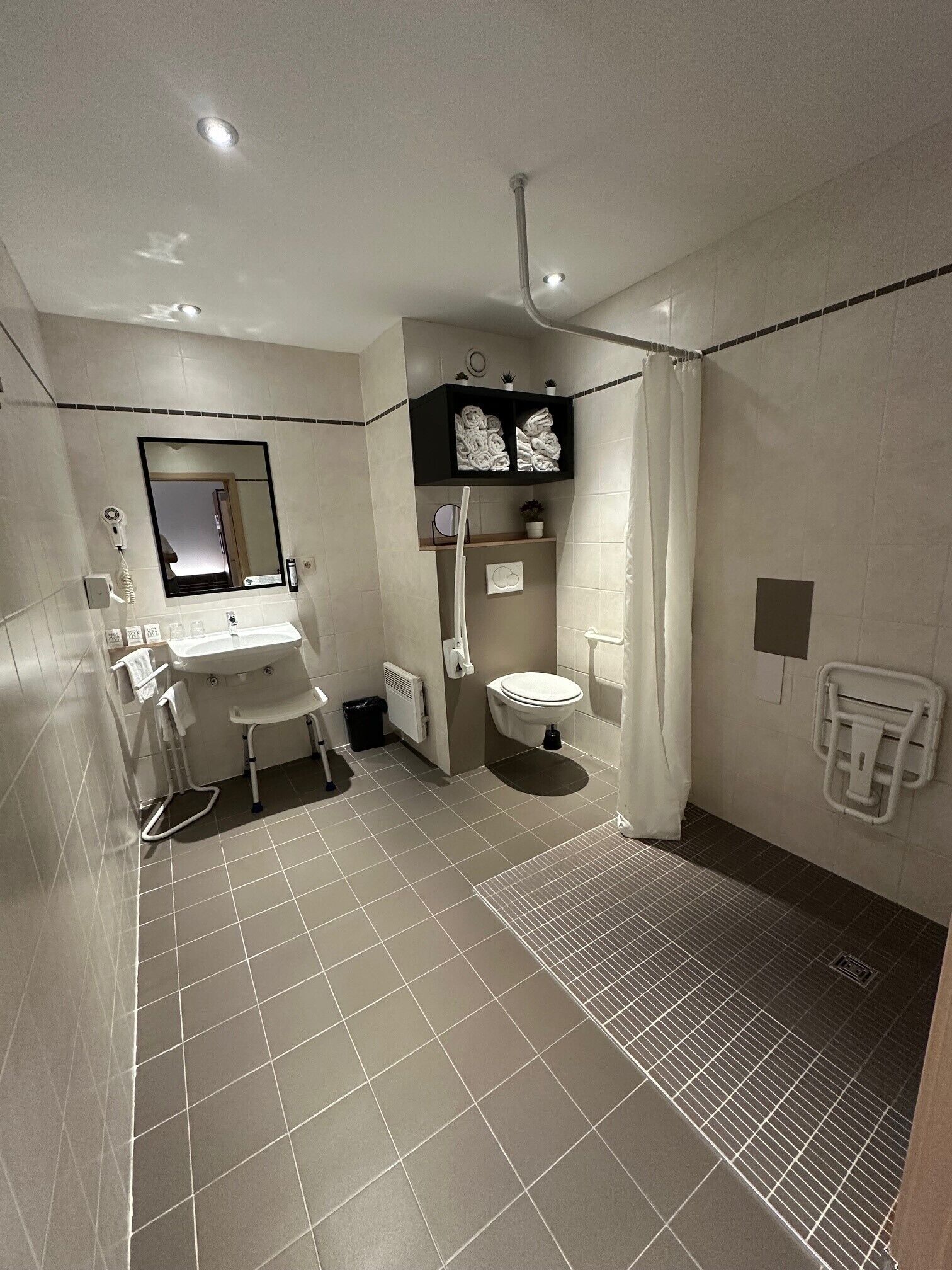 A modern bathroom with a sink, toilet, and shower.