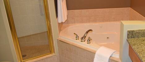 A bathroom with a bathtub, a shower, and a toilet.