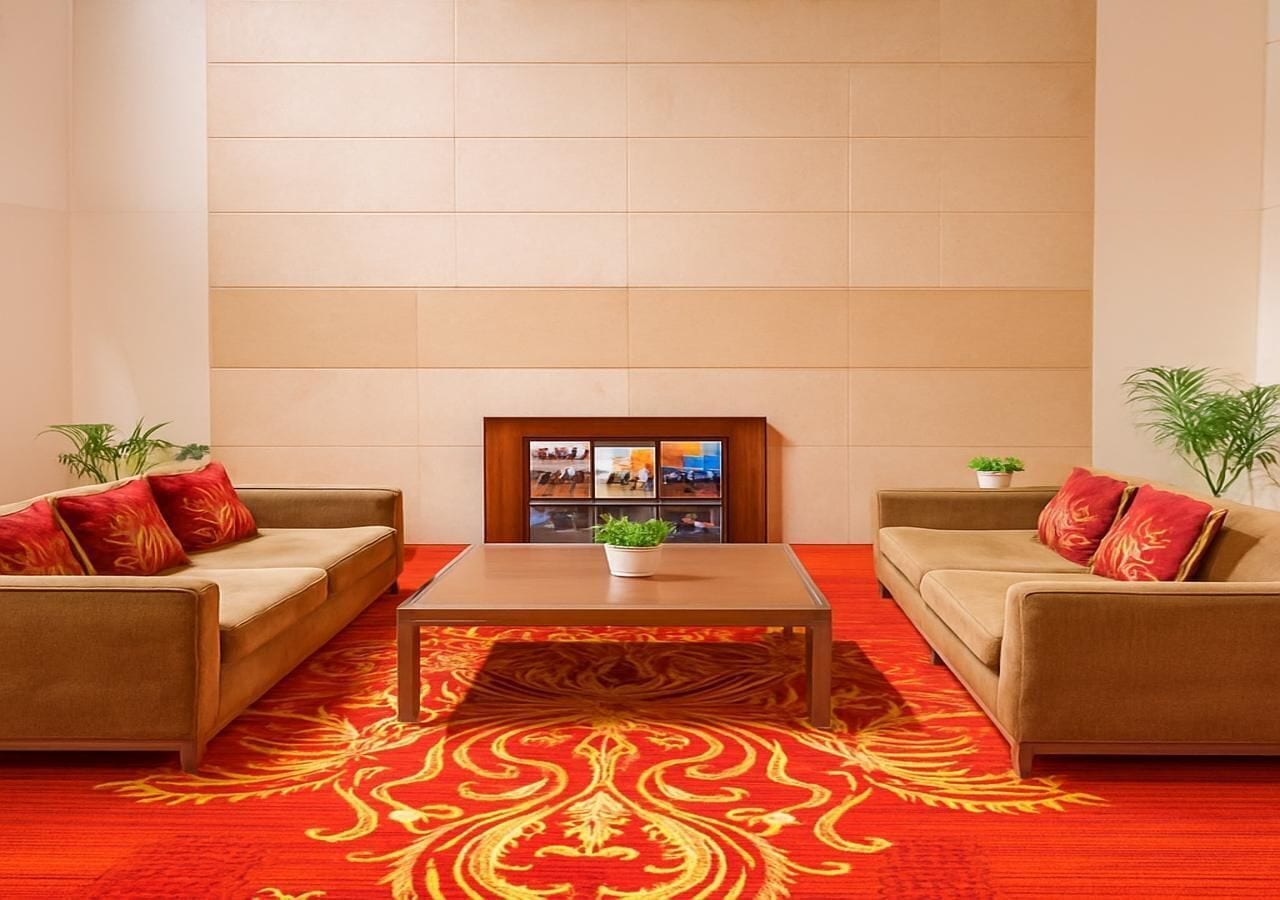 A room with two sofas, a coffee table, and a wall-mounted TV.