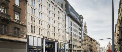 A multi-story hotel with a classic facade, large windows, and a prominent entrance.