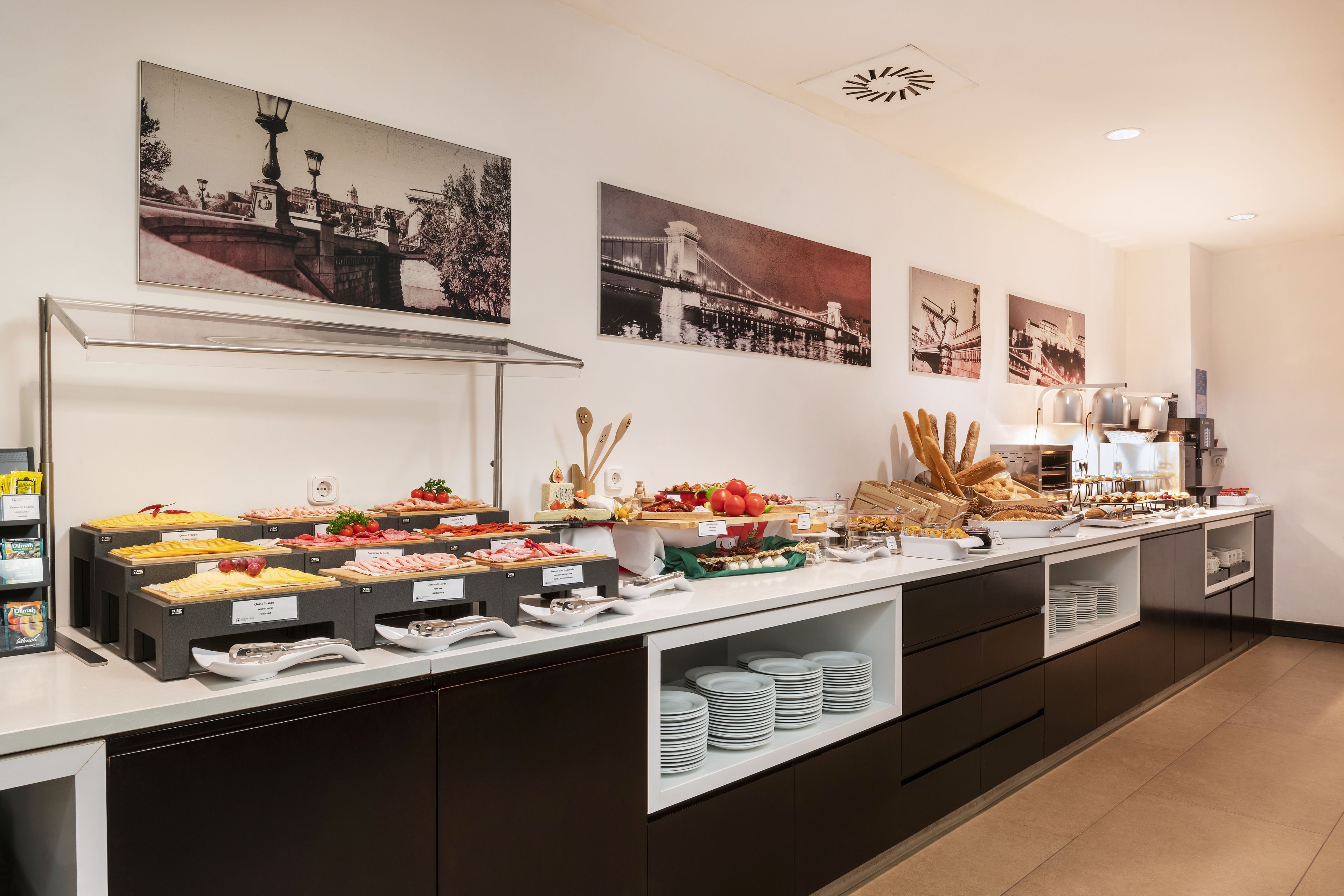 A buffet with various food items and a coffee station.