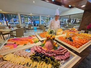 A buffet with various meats and vegetables. - Thai Garden Resort (Pattaya)