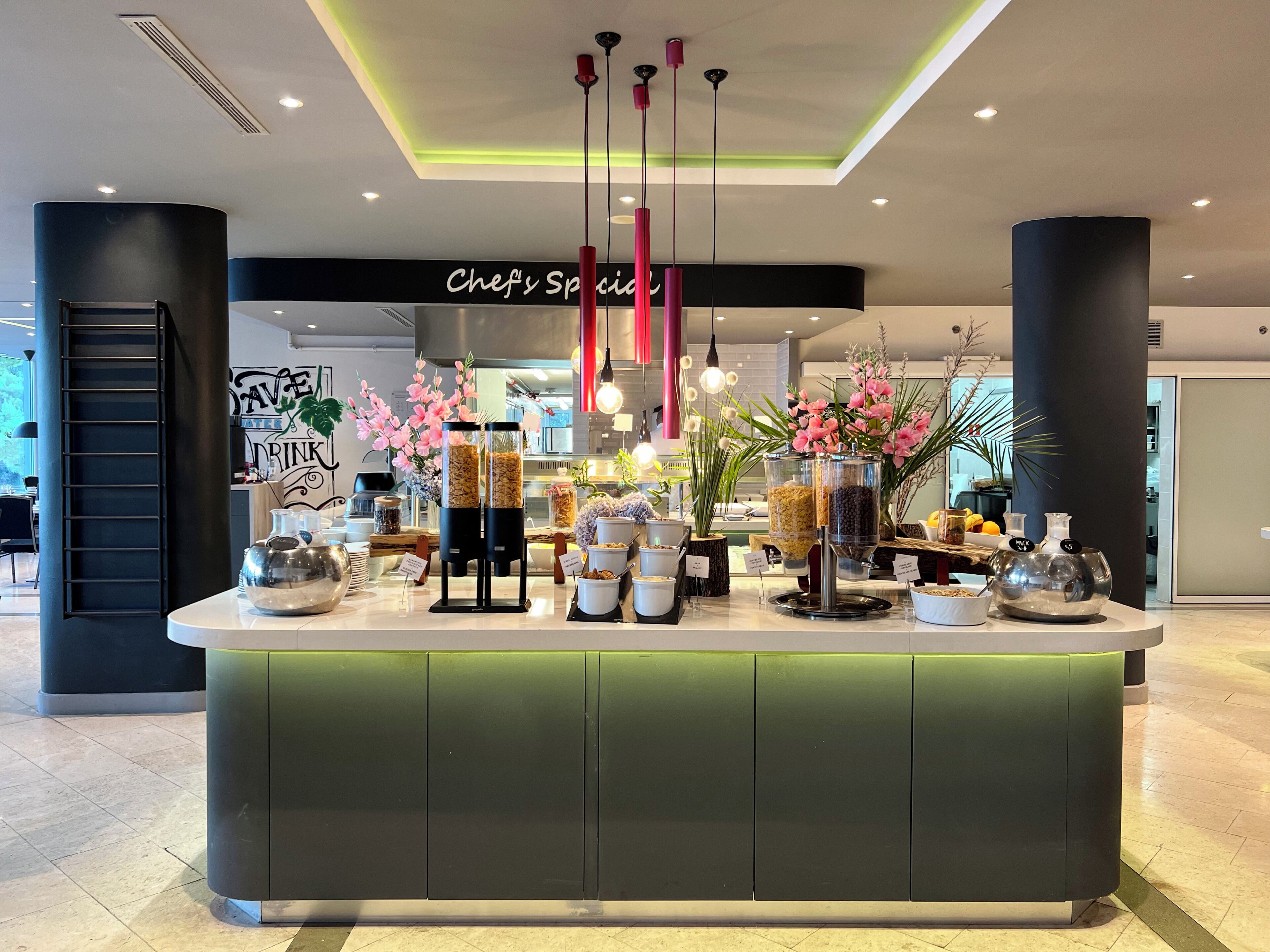 A counter with food items, a sign reading 'Chef's Special', and a modern interior design.