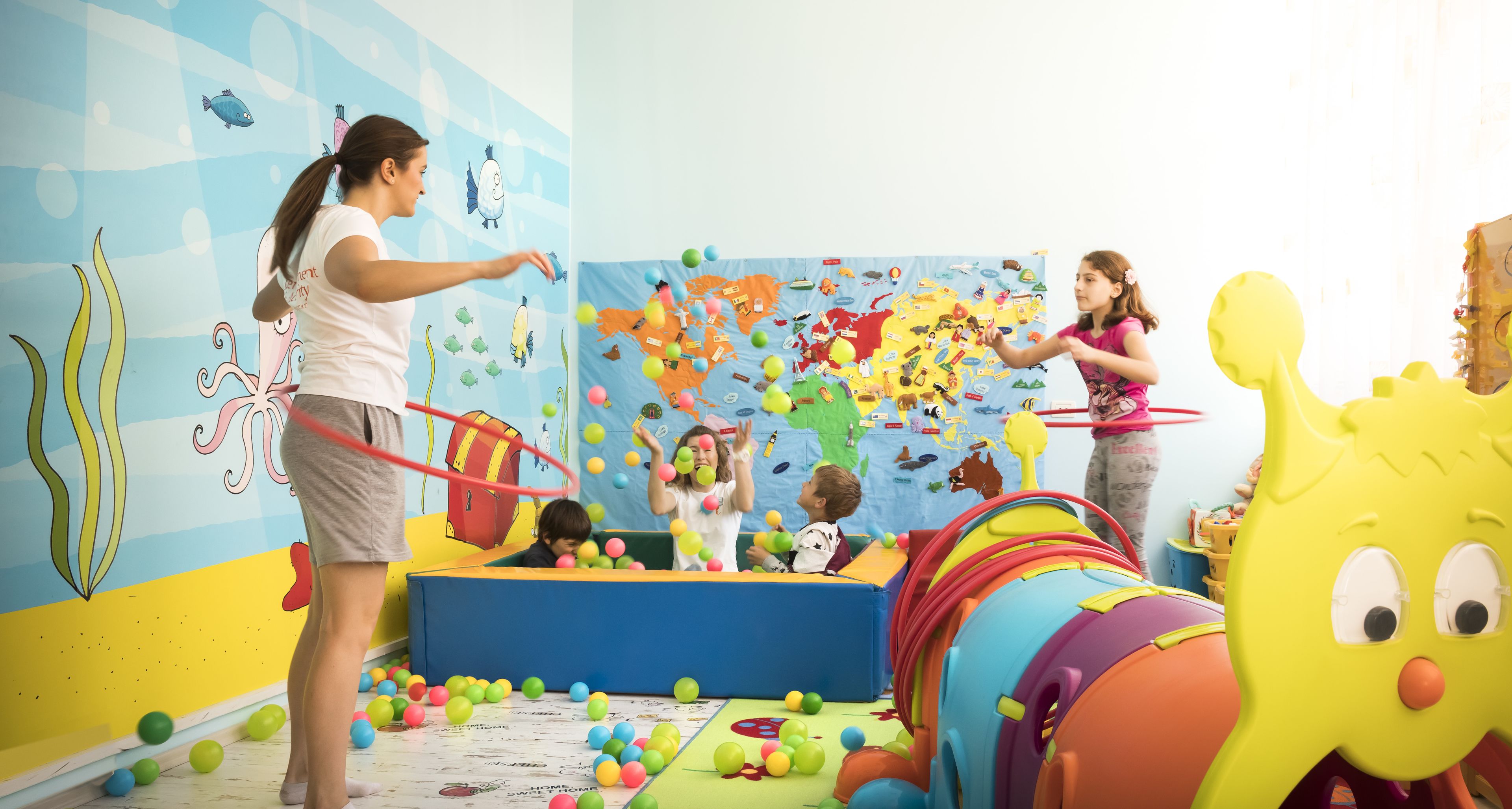 A play area with colorful toys and a large inflatable slide.
