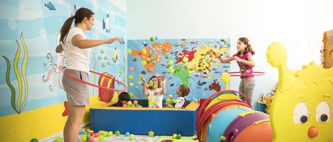 A play area with colorful toys and a large inflatable slide.
