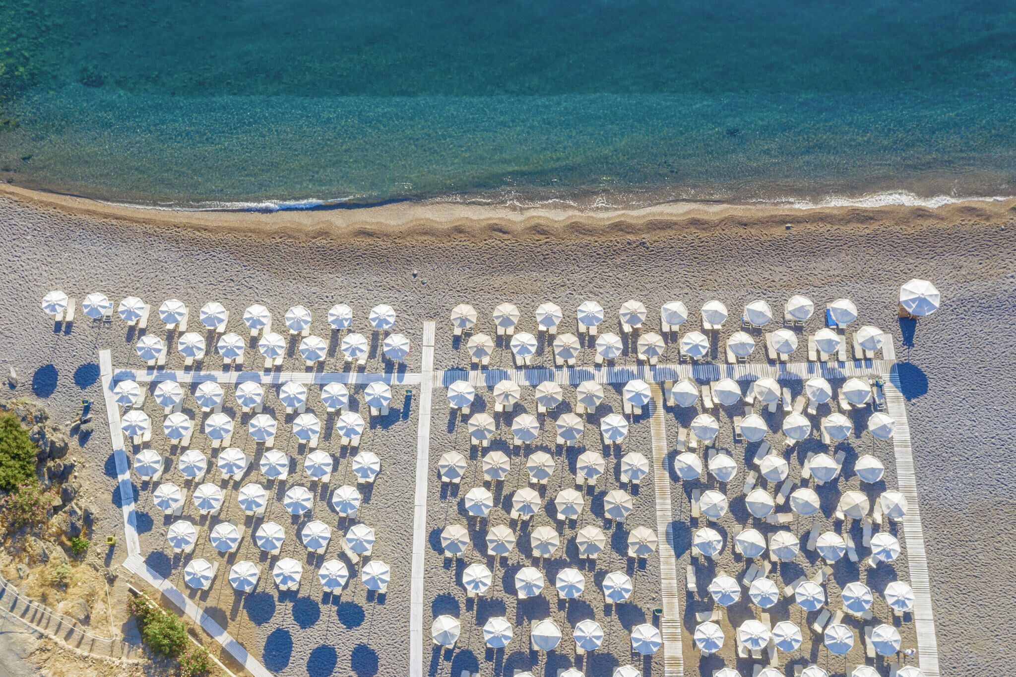 On the beach, black sand, sun-loungers, beach umbrellas