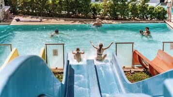Enjoy a refreshing swim in our pool surrounded by lush greenery and lounge under the shade of umbrellas.
