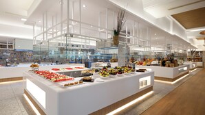 A modern buffet area with a variety of food options, including fruits, pastries, and salads. - Iberostar Waves Mehari Djerba (Djerba Midun)