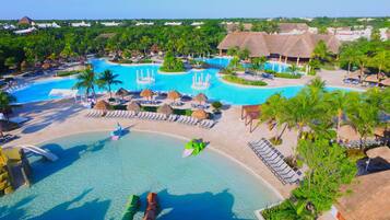 Relax by the resort's central pool surrounded by lounge areas and lush greenery.