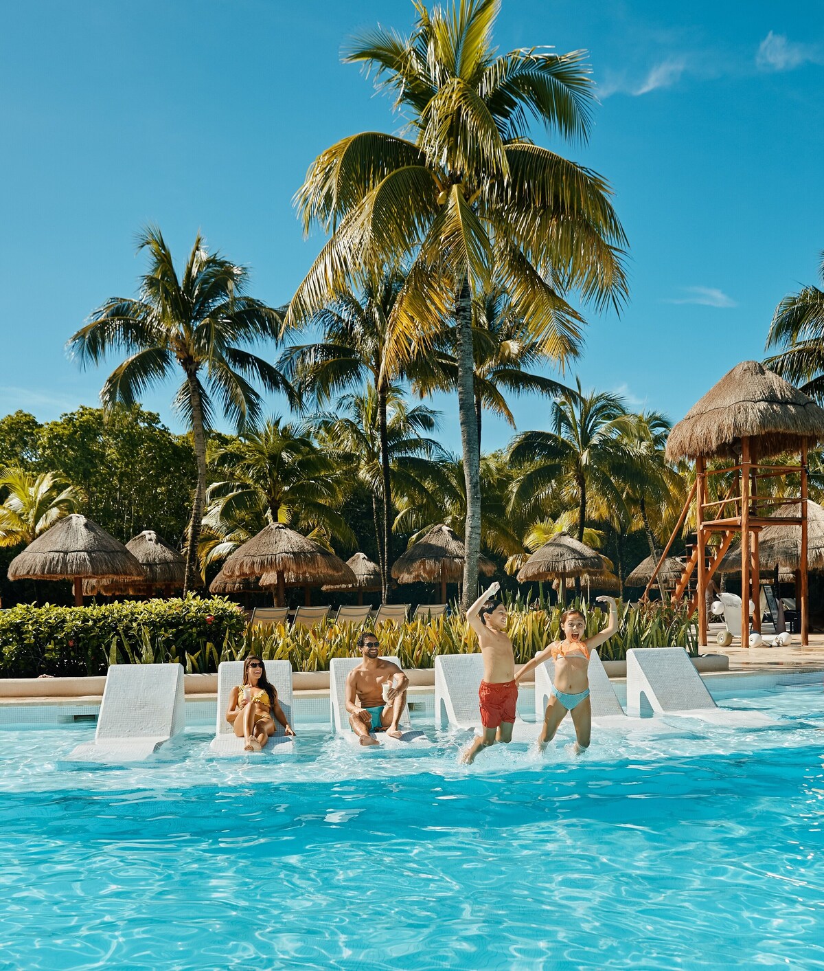 family enjoying the pool of Grand Palladium Colonial Resort & Spa - All Inclusive