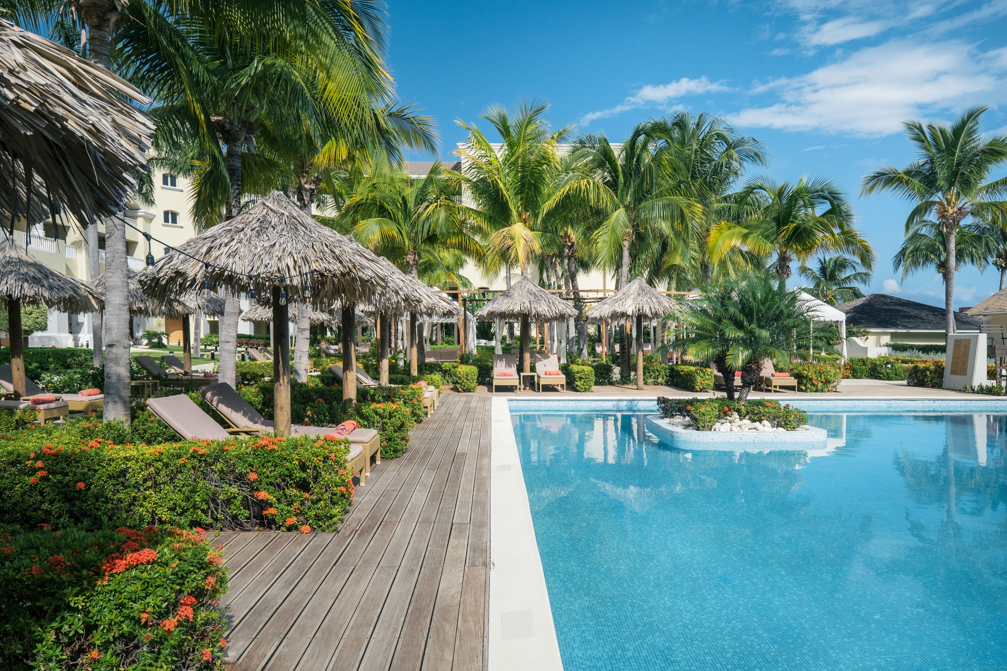 Una piscina al aire libre, camas de piscina gratis, sombrillas