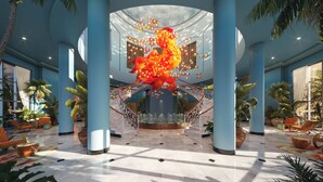 A spacious lobby with a central fountain, palm trees, and a large sculpture. - JOIA Rose Hall by Iberostar - Adults Only - All Inclusive (Montego Bay)