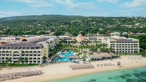 A resort with a central pool, multiple buildings, and a beach. - JOIA Rose Hall by Iberostar - Adults Only - All Inclusive (Montego Bay)