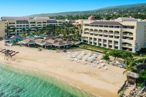 A resort with multiple buildings, a beach, and a pool area. - JOIA Rose Hall by Iberostar - Adults Only - All Inclusive (Montego Bay)