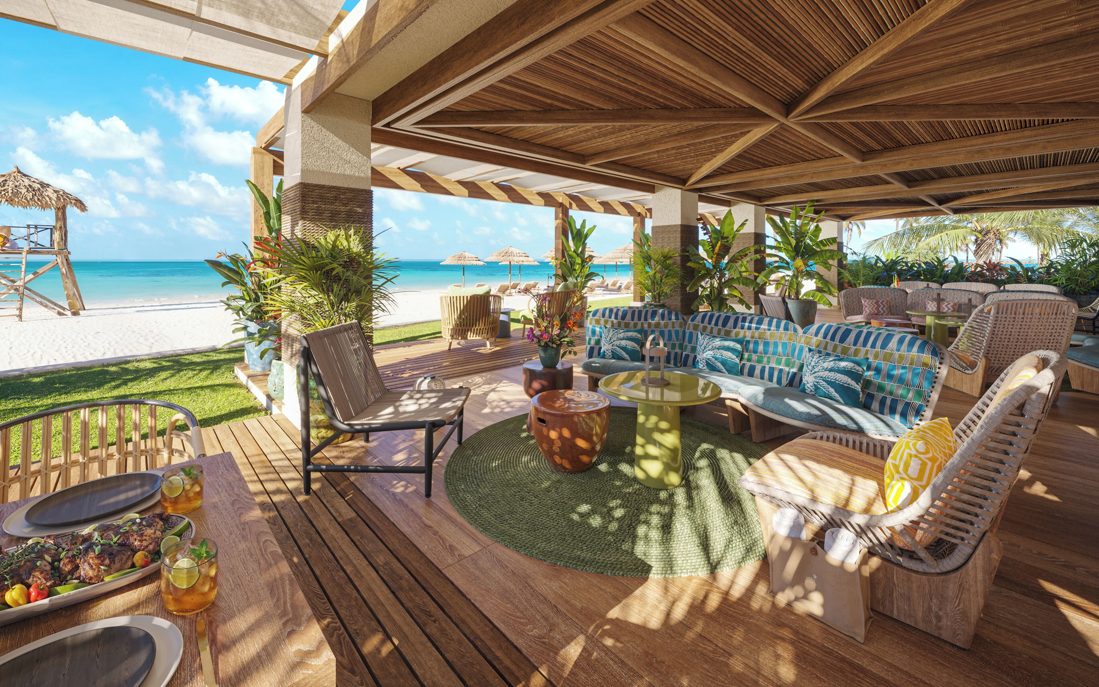 An outdoor seating area with a view of the beach, wooden furniture, and potted plants.