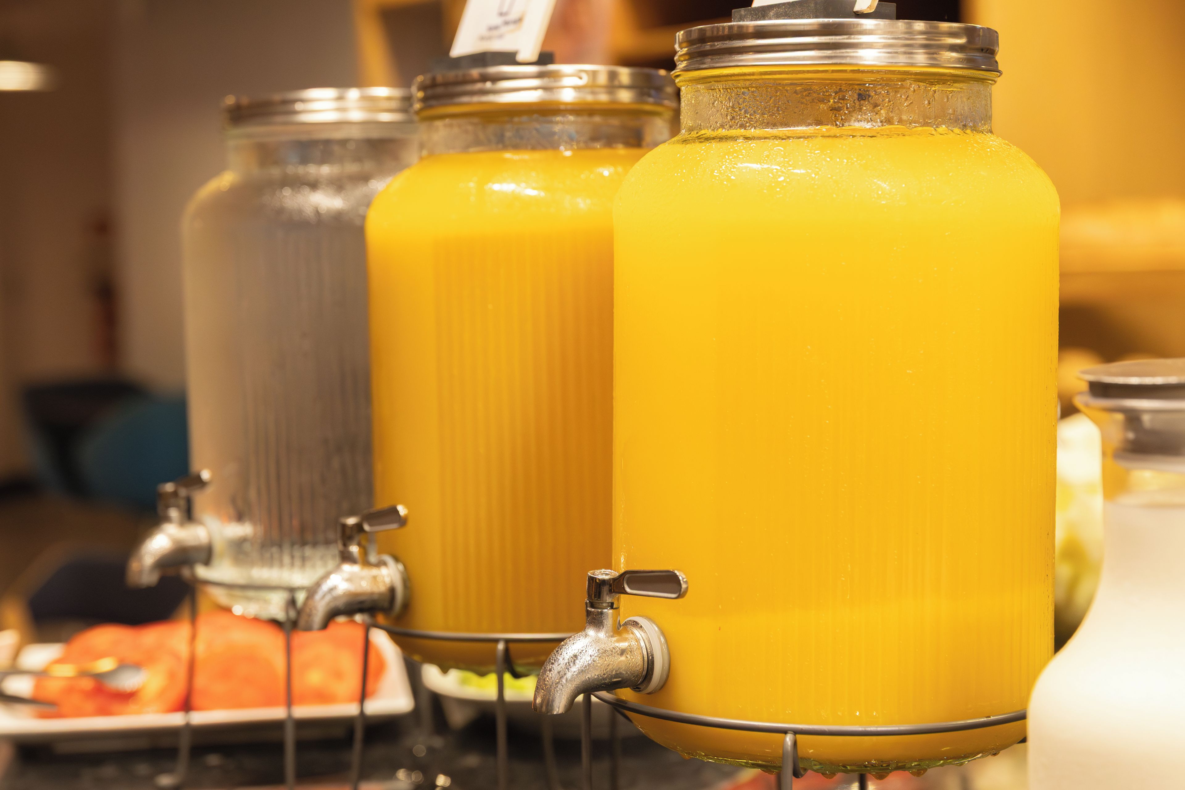 A juice dispenser with multiple containers.