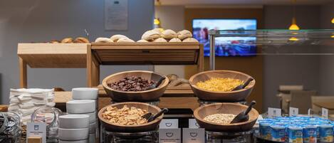A breakfast buffet with various food items and containers.