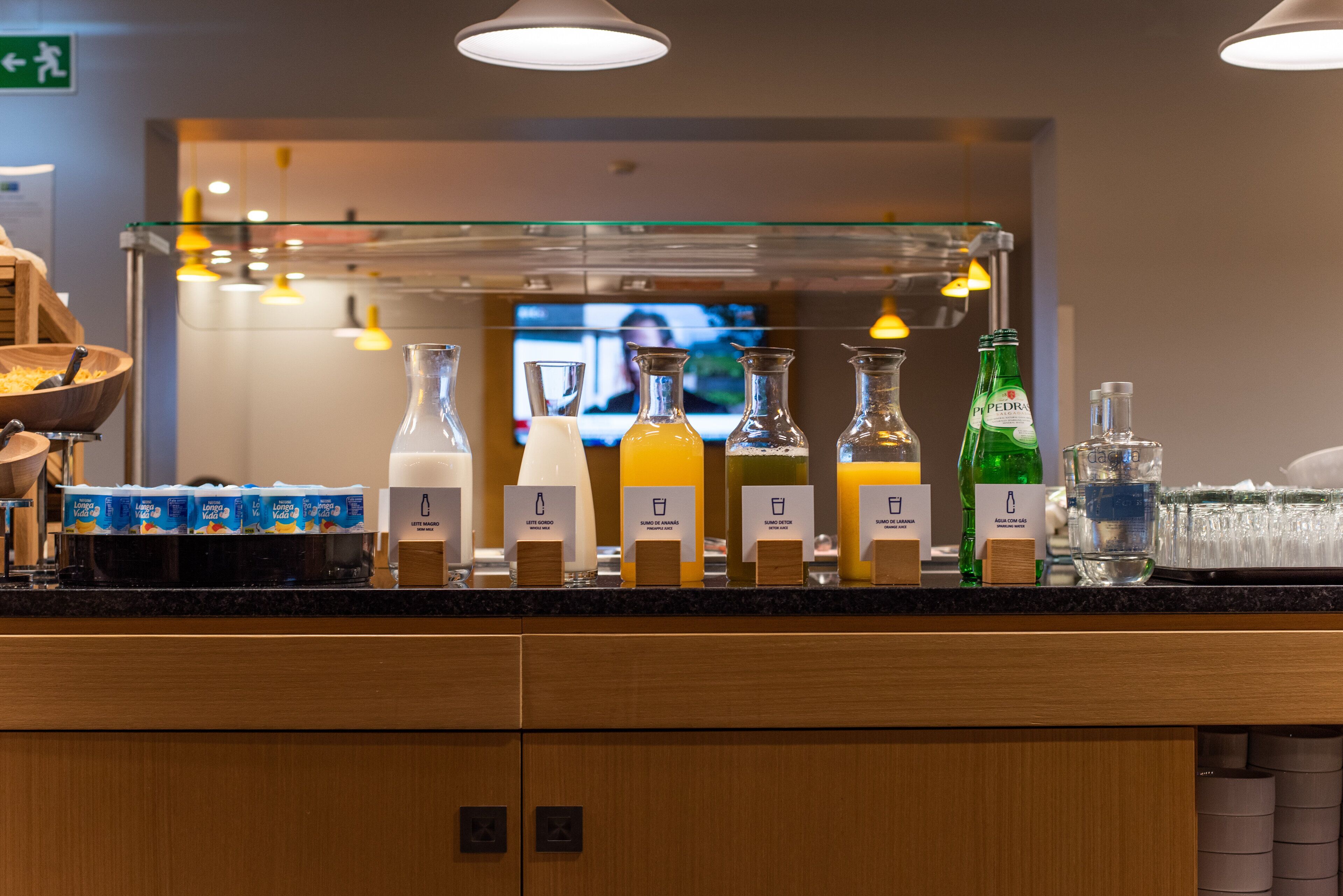 A hotel bar area with various beverages and a bowl of cereal.
