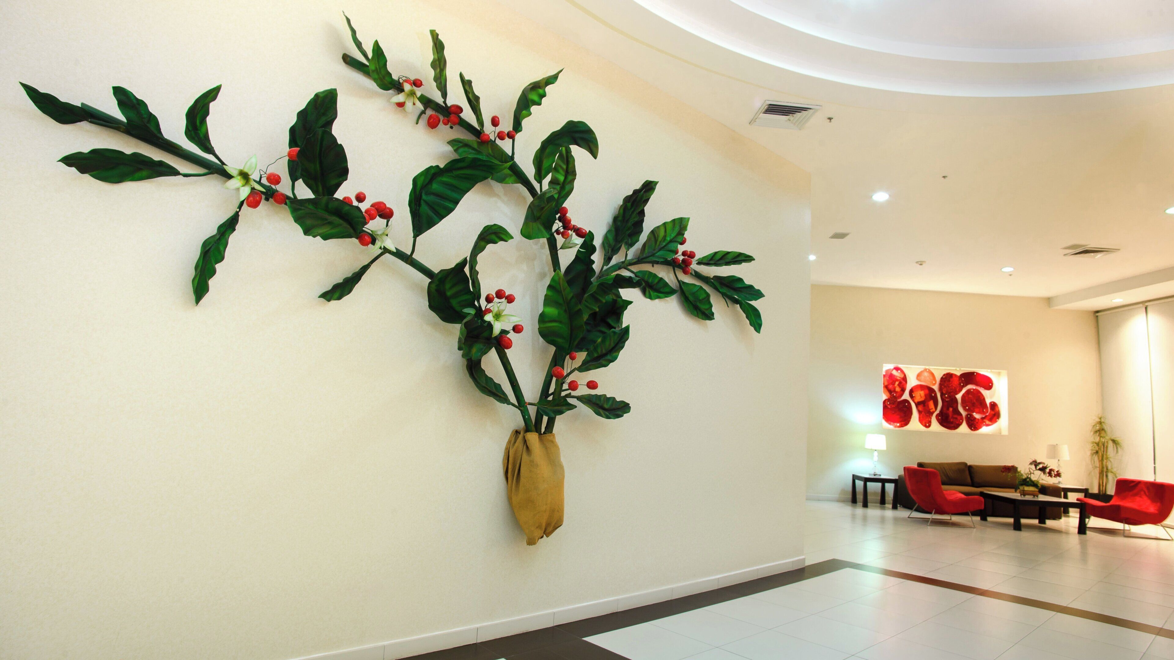 A modern interior with a wall-mounted artificial plant arrangement.