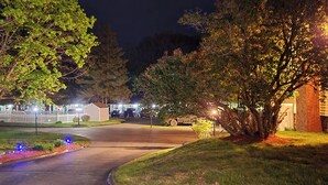 A residential street at night with houses, trees, and a driveway. - Tallwood Motel Wells (Wells)