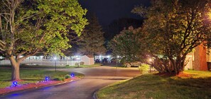 A residential street at night with houses, trees, and a driveway. - Tallwood Motel Wells (Wells)