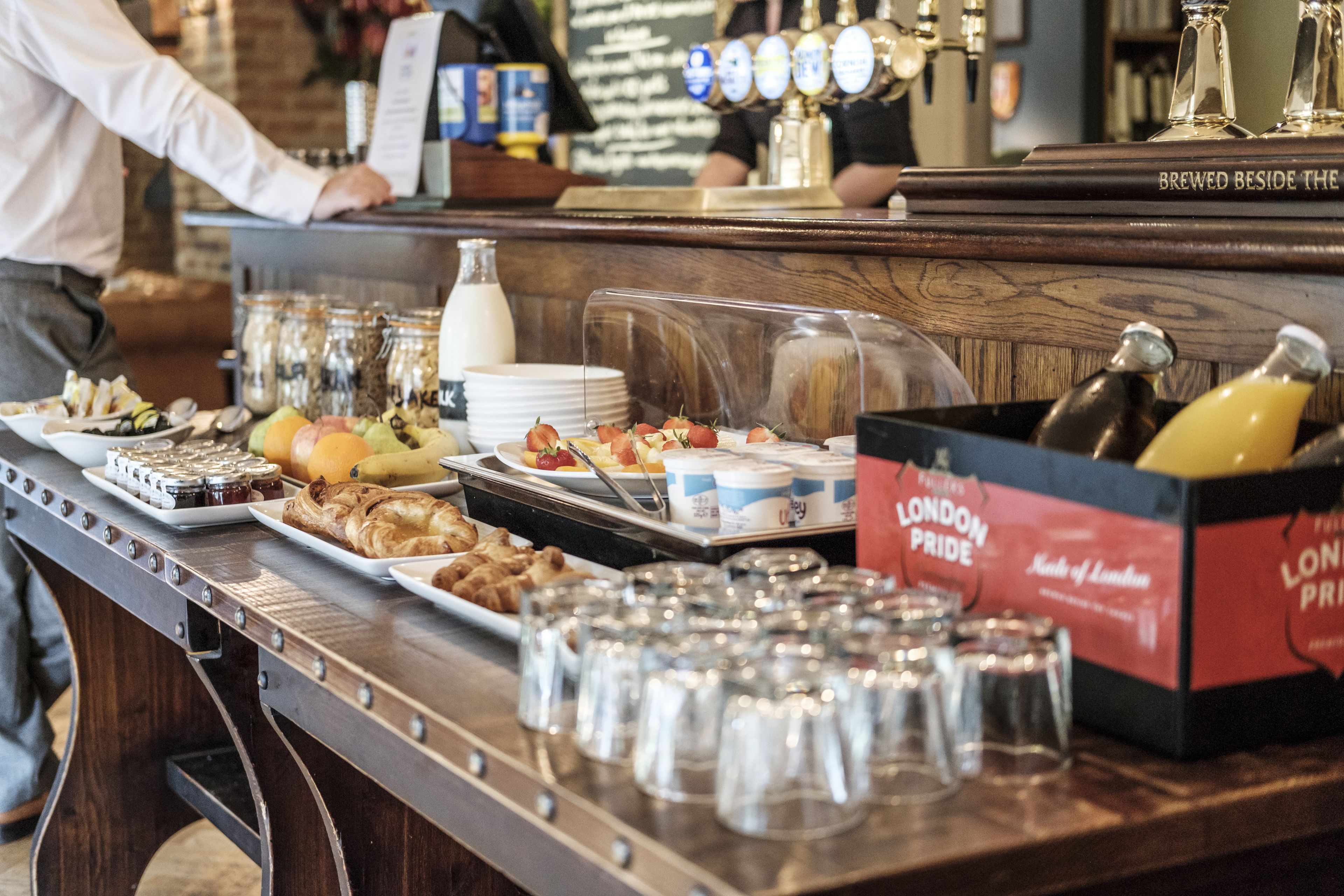 A buffet with various food items and beverages, including a section labeled "London Pride."